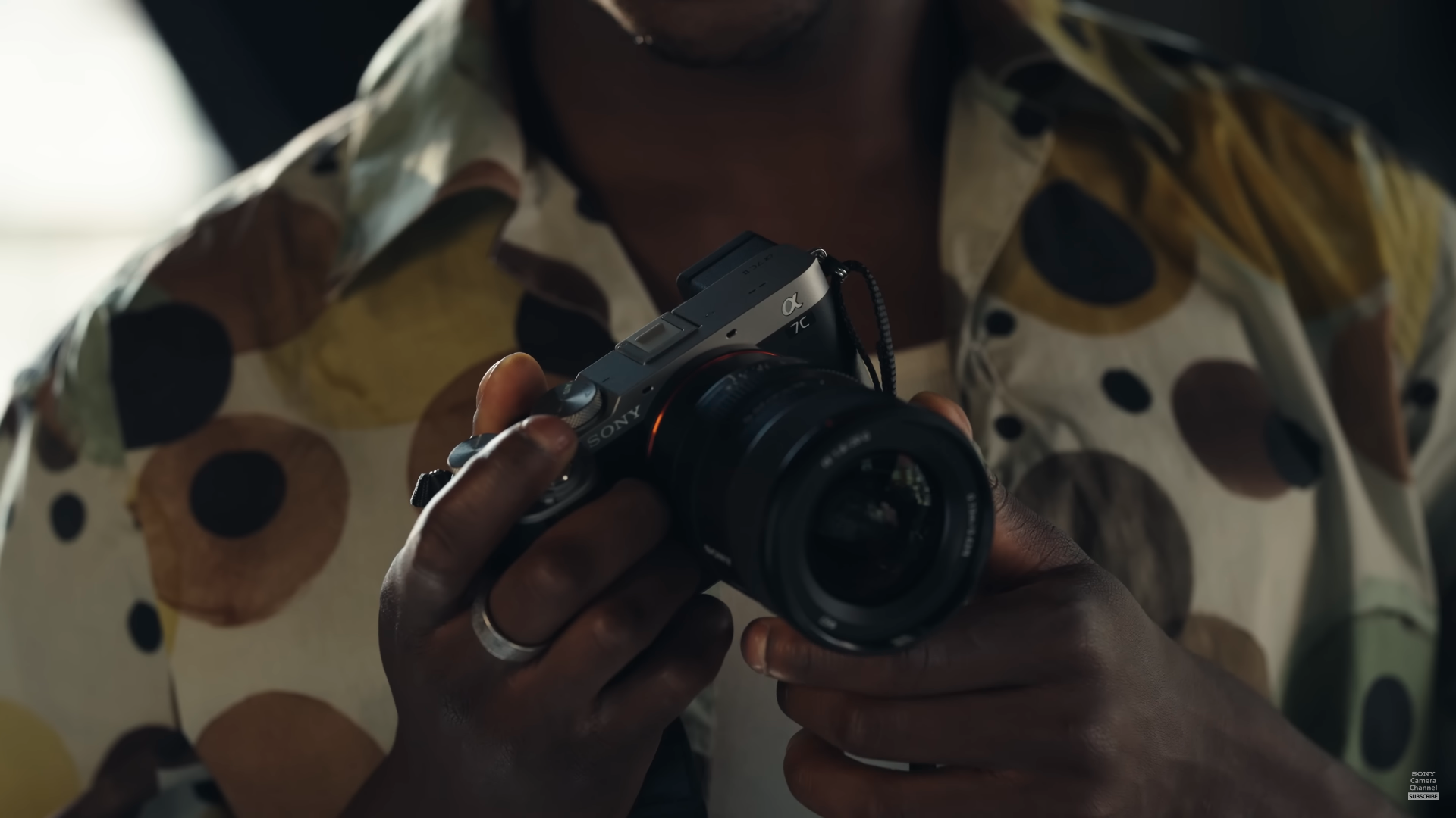 Close-up of Sony Alpha 7C II being held up by a user