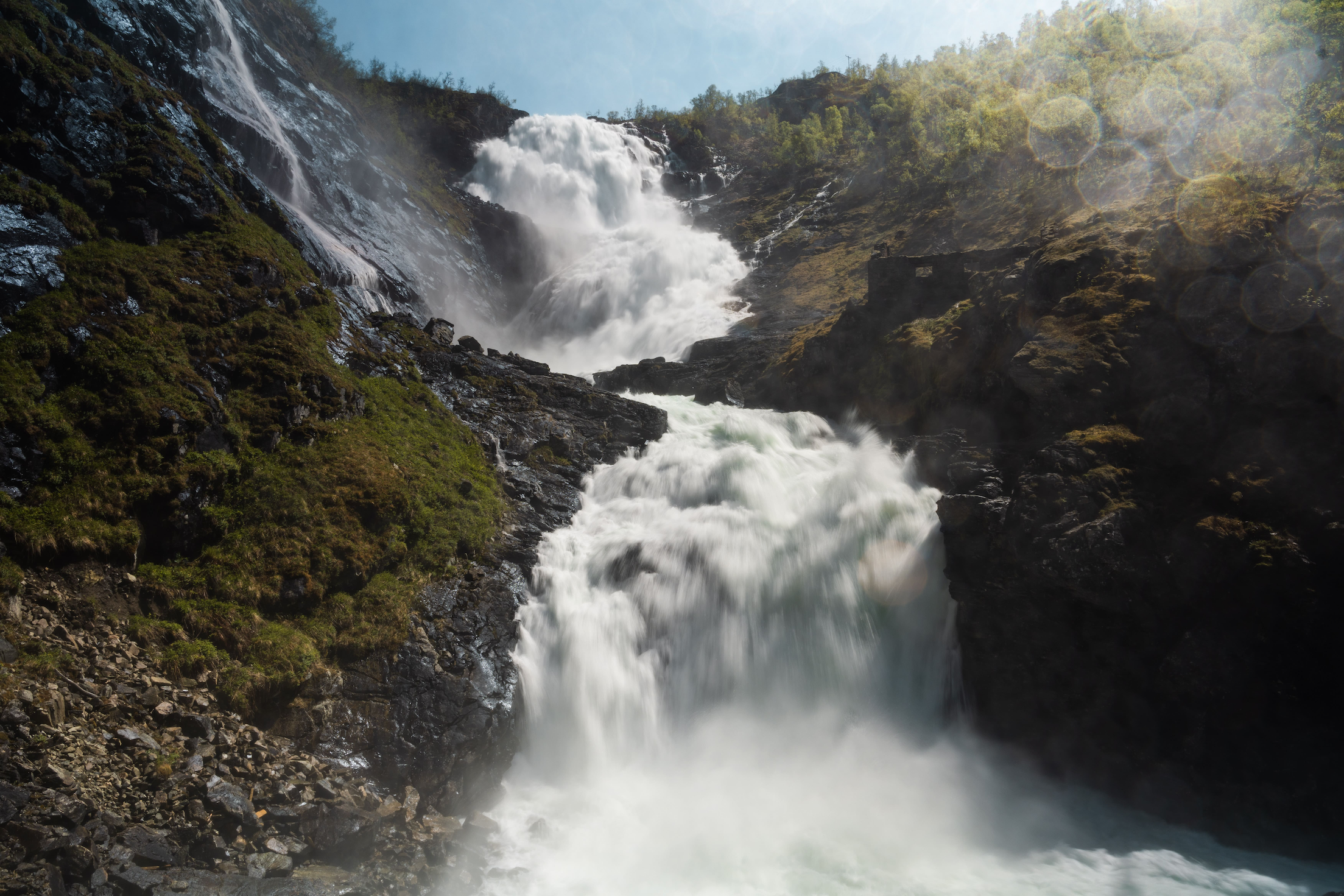 Low-angle view of a roaring multi-levelled waterfall