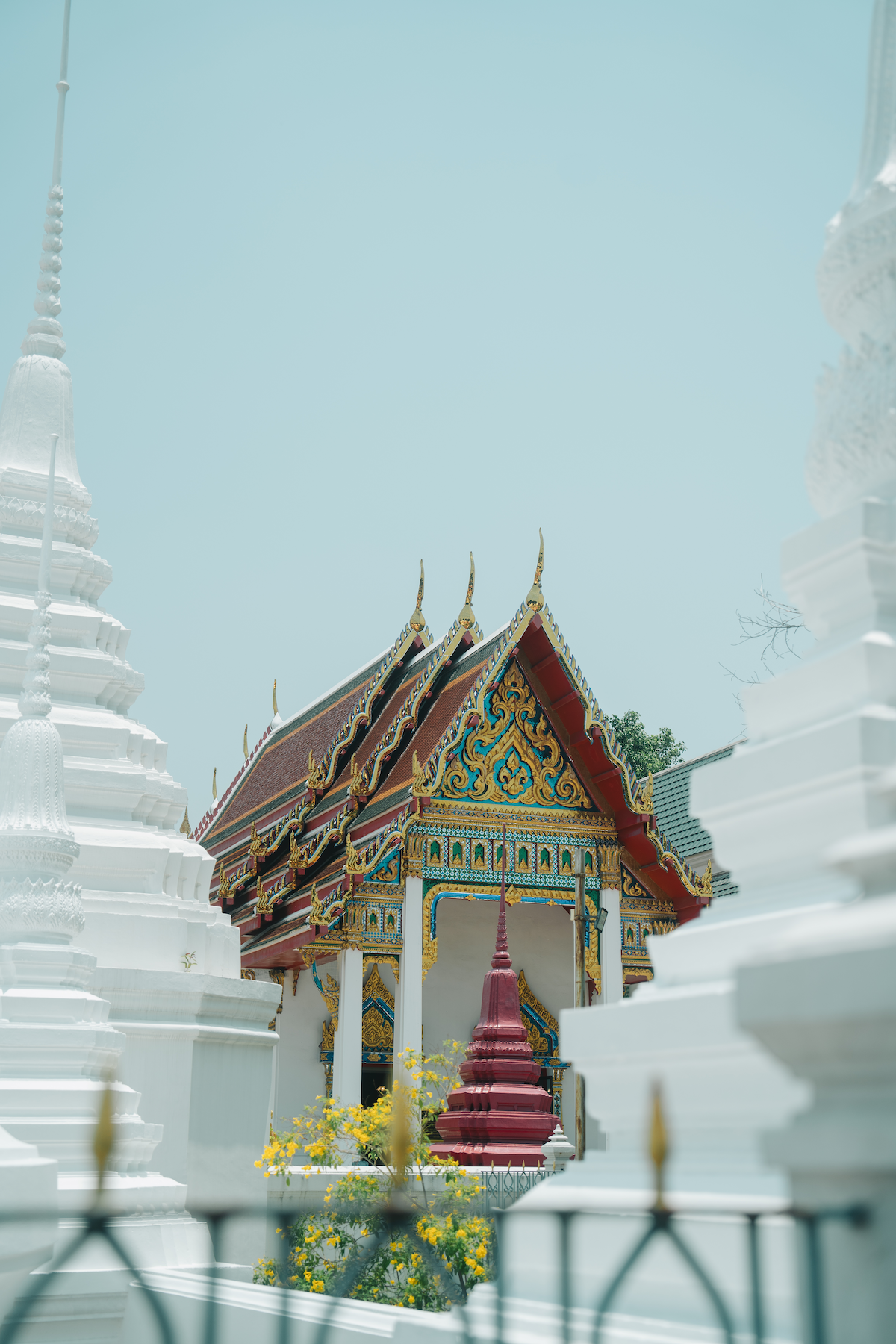 Colourful architecture details amidst the white structures in the Wat Pho Temple